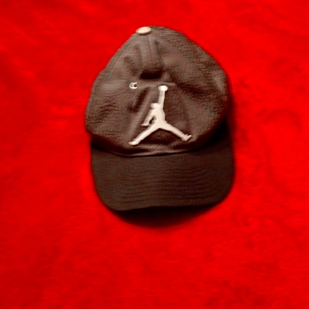 Jordan youth gray and black adjustable back.